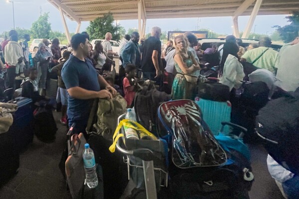 French and other nationals gather at the international Airport to be airlifted back to France on a French military aircraft, in Niamey, Niger, Wednesday, Aug. 2, 2023, to be airlifted back to France on a French military aircraft. French forces in the capital, Niamey, evacuated hundreds of mostly French nationals to Paris on two flights Tuesday, following concerns that their citizens and other Europeans risked becoming trapped by last week’s military coup, which ousted and detained President Mohamed Bazoum. (AP Photo/Sam Mednick)