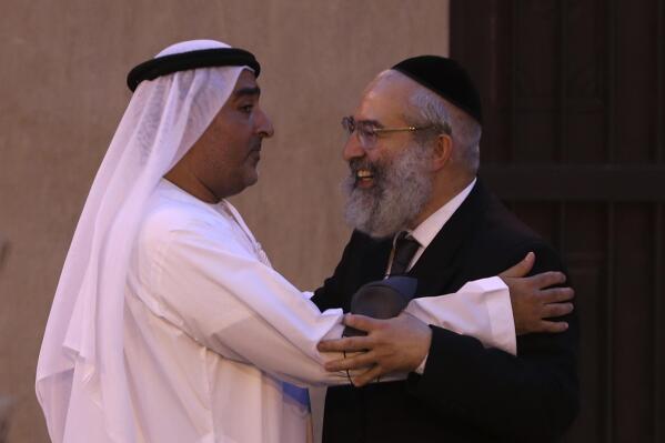 Ahmed Al Mansuri, founder of Crossroads of Civilization private museum, left, greets a rabbi at an exhibition commemorating the Jewish Holocaust in Dubai, United Arab Emirates, Wednesday, May 26, 2021. Israel's top diplomat to the United Arab Emirates attended a ceremony in Dubai on the grounds of the Arabian Peninsula's first permanent exhibition to commemorate the Holocaust. Hours earlier, he'd attended an event establishing a joint venture between an Israeli and Emirati company. (AP Photo/Kamran Jebreili)