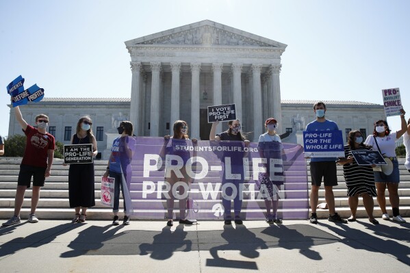 In this June 29, 2020 file photo, Anti-abortion protesters wait outside the Supreme Court for a decision, in Washington on the Louisiana case, Russo v. June Medical Services LLC. (AP Photo/Patrick Semansky, file)