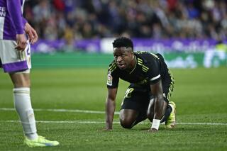 FILE - Real Madrid's Vinicius Junior gets up from the ground during a Spanish La Liga soccer match between Valladolid and Real Madrid at the Jose Zorrilla stadium in Valladolid, Spain, Dec. 30, 2022. Spanish league club Valladolid has on Friday, Feb. 10, 2023 suspended 12 season-ticket holders while it and authorities investigate their alleged use of verbal racist attacks against Real Madrid player Vinicius Junior. The incident occurred during Madrid’s 2-0 win at Valladolid on Dec. 30. (AP Photo/Pablo Garcia, file)