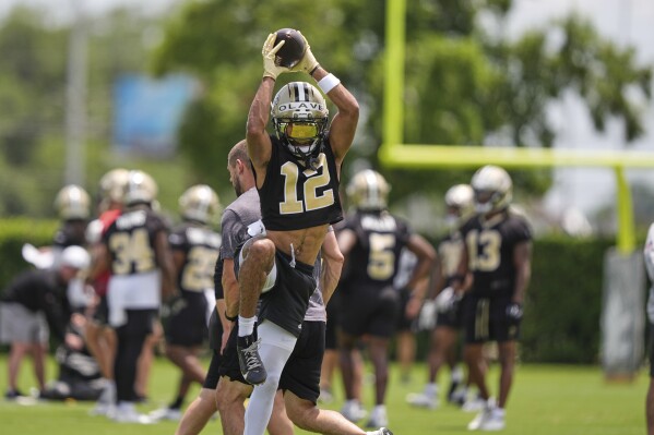 New Orleans Saints wide receiver Chris Olave (12) goes through drills during practice at NFL football minicamp in Metairie, La., Wednesday, June 11, 2025. (AP Photo/Gerald Herbert)
