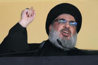 FILE - In this Oct. 24, 2015 file photo, Hezbollah leader Sheik Hassan Nasrallah addresses a crowd during the holy day of Ashoura, in a southern suburb of Beirut, Lebanon. On Monday, Oct. 18, 2021, Nasrallah revealed that his militant group has 100,000 trained fighters. (AP Photo/Hassan Ammar, File)