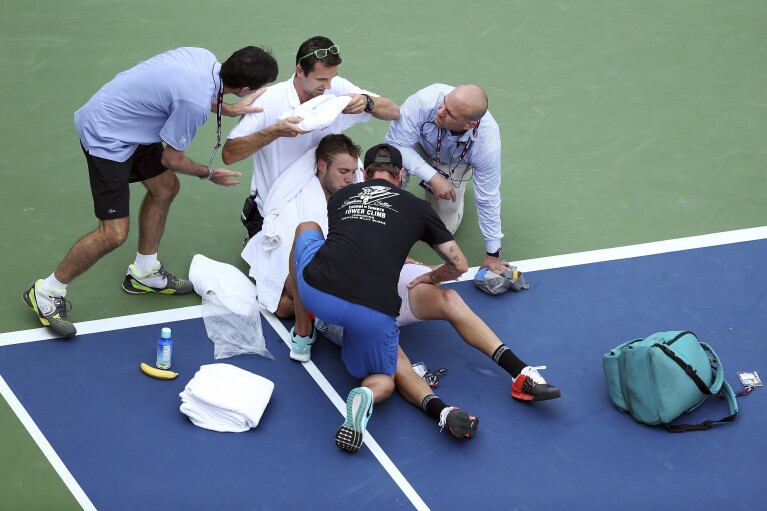 Jack Sock is tended to by medical personnel after collapsing on the court during play against Ruben Bemelmans, of Belgium, during the second round of the U.S. Open tennis tournament, Sept. 3, 2015, in New York. (AP Photo/Adam Hunger, File)