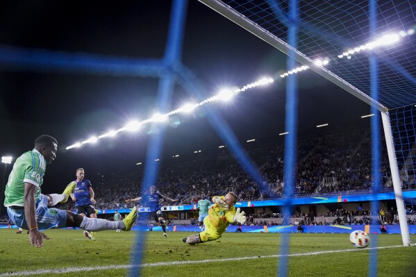Seattle Sounders goalkeeper Stefan Frei, center, is unable to stop a goal by San Jose Earthquakes forward Cristian Espinoza during the first half of an MLS soccer match Saturday, March 23, 2024, in San Jose, Calif. (AP Photo/Godofredo A. Vásquez)
