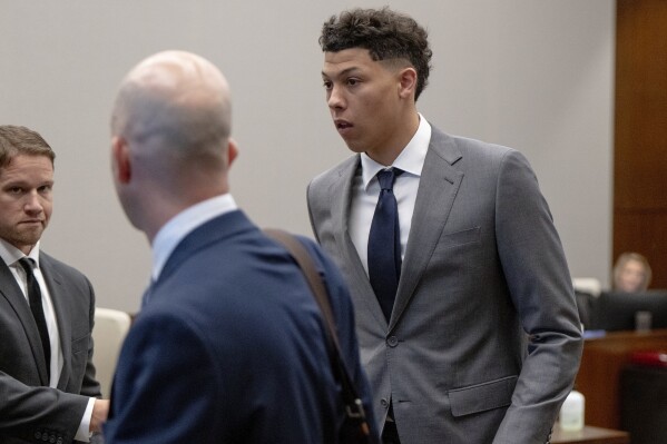 FILE - Jackson Mahomes, right, leaves the courtroom following a bond motion hearing in Johnson County District Court on Tuesday, May 16, 2023, in Olathe, Kan. The preliminary hearing in the felony case for Jackson Mahomes, the brother of Kansas City Chiefs quarterback Patrick Mahomes, has been pushed back nearly a month because the judge has COVID-19. Jackson Mahomes was charged in May with three felony counts of aggravated sexual battery and one misdemeanor count of battery.(Nick Wagner/The Kansas City Star via AP, File)