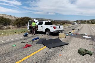 Debris is strewn across a road near the border city of Del Rio, Texas after a collision Monday, March 15, 2021. Eight people in a pickup truck loaded with immigrants were killed when the vehicle collided with an SUV following a police chase, authorities said. (Texas Department of Public Safety via AP)