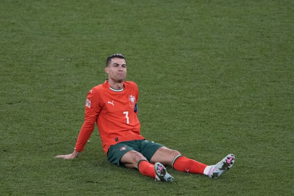 Portugal's Cristiano Ronaldo lies on the ground during the Nations League final soccer match between Portugal and Spain at the Allianz Arena in Munich, Germany, Sunday, June 8, 2025. (AP Photo/Michael Probst)