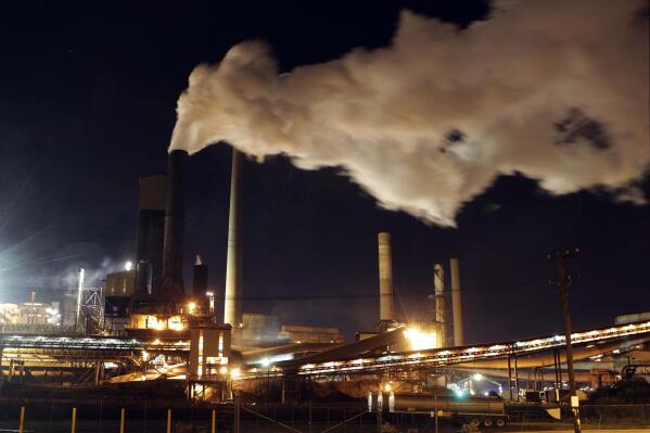 In this July 8, 2011 file photo, smoke bellows from a chimney stack at BlueScope Steel's mill at Port Kembla, south of Sydney, Australia. Australia was the worst climate performer among comparable developed countries since the 2015 Paris Agreement imposed binding commitments to limit global warming, a think tank reported on Thursday Oct. 21, 2021, ahead of an important conference in Scotland later this month. (AP Photo/Rob Griffith, File)