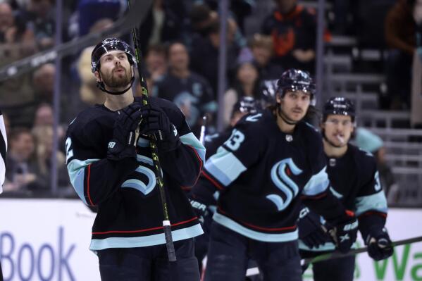Seattle Kraken right wing Oliver Bjorkstrand (22) looks up as he skates to the bench after scoring against the San Jose Sharks during the third period of an NHL hockey game Wednesday, Nov. 23, 2022, in Seattle. The Kraken won 8-5. (AP Photo/John Froschauer)