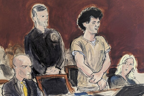 In this courtroom sketch, Sam Bankman-Fried, second from right, stands while making a statement during his sentencing in Manhattan federal court, Thursday, March. 28, 2024, in New York. Crypto entrepreneur Bankman-Fried was sentenced Thursday to 25 years in prison for a massive fraud that unraveled with the collapse of FTX, once one of the world's most popular platforms for exchanging digital currency. (Elizabeth Williams via AP)