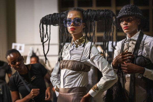 Models get ready backstage for South African designer Gavin Rajah's show during Johannesburg Fashion Week 2023 in Johannesburg, South Africa, Thursday, Nov. 9, 2023. (AP Photo/Jerome Delay)