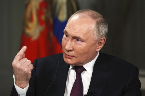 In this photo released by Sputnik news agency on Friday, Feb. 9, 2024, Russian President Vladimir Putin gestures while speaking during an interview with former Fox News host Tucker Carlson at the Kremlin in Moscow, Russia, Tuesday, Feb. 6, 2024. (Gavriil Grigorov, Sputnik, Kremlin Pool Photo via 番茄直播)