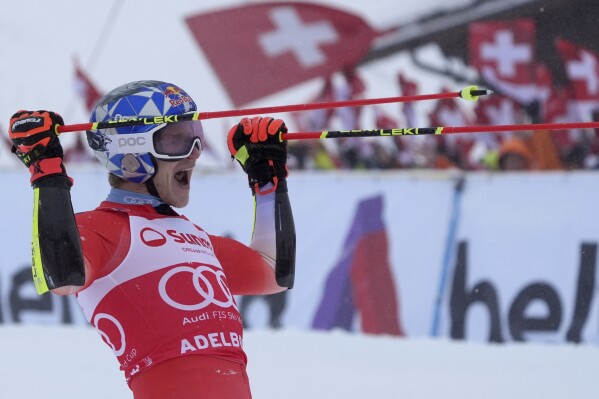 Switzerland's Marco Odermatt celebrates winning an alpine ski, men's World Cup giant slalom race, in Adelboden, Switzerland, Saturday, Jan. 6, 2024. (AP Photo/Giovanni Auletta)