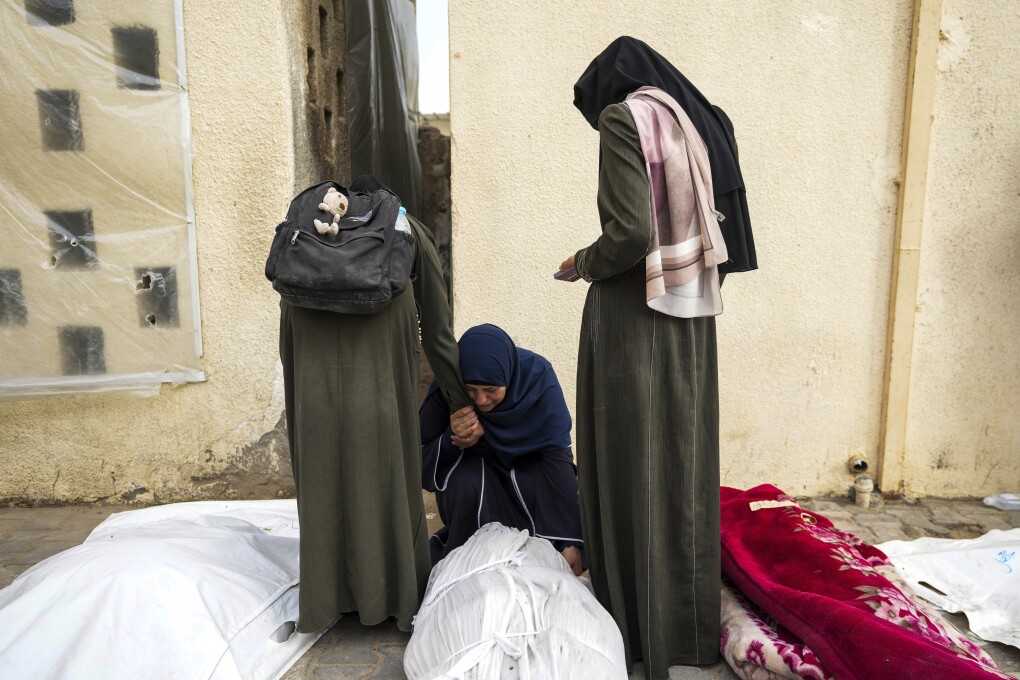 Palestinians mourn their relatives killed in the Israeli bombardments of the Gaza Strip in front of the morgue of the Al Aqsa Hospital in Deir al Balah, Gaza Strip, on Saturday, May 11, 2024. (AP Photo/Abdel Kareem Hana)