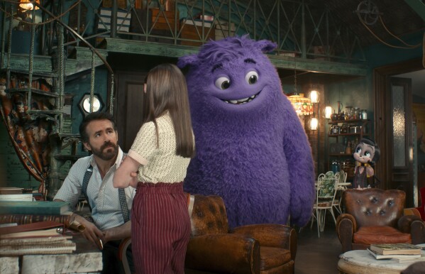 This image released by Paramount Pictures shows Ryan Reynolds, from left, Cailey Fleming, the character Blue, voiced by Steve Carell, and the Blossom, voiced by Phoebe Waller-Bridge, in a scene from "IF." (Paramount Pictures via AP)