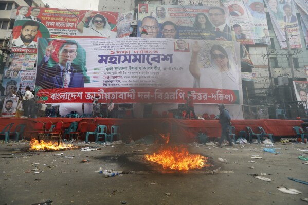 Smoke rises from flames near the stage set for a protest by the Bangladesh Nationalist Party in Dhaka, Bangladesh, Saturday, Oct. 28, 2023. Police in Bangladesh's capital fired tear gas to disperse supporters of the main opposition party who threw stones at security officials during a rally demanding the resignation of Prime Minister Sheikh Hasina and the transfer of power to a non-partisan caretaker government to oversee general elections next year. (AP Photo/Mahmud Hossain Opu)