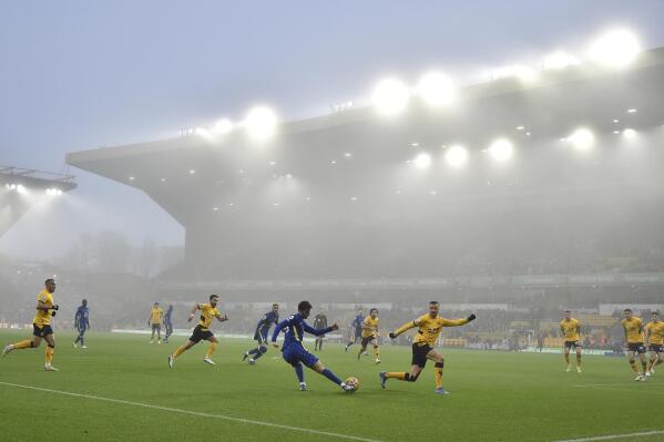 Fog envelopes the field during the English Premier League soccer match between Wolverhampton Wanderers and Chelsea at Molineux stadium in Wolverhampton, England, Sunday, Dec. 19, 2021. (AP Photo/Rui Vieira)