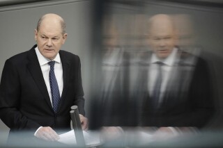 FILE - Germany's Chancellor Olaf Scholz makes a government statement in the Bundestag, Berlin, Wednesday, Dec. 13, 2023. German Chancellor Olaf Scholz is calling for calm and a readiness to accept compromises as the country faces protests by farmers angry about a plan to cut their fuel subsidies. He warned Saturday of a danger from extremists stoking rage against a backdrop of wider discontent. (Kay Nietfeld/dpa via AP, File)