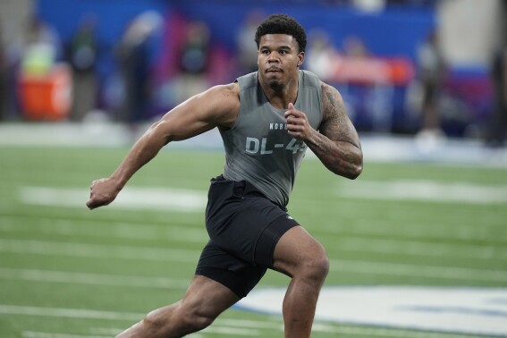 FILE - Penn State defensive lineman Chop Robinson runs a drill at the NFL football scouting combine Feb. 29, 2024, in Indianapolis. The Miami Dolphins selected Robinson with the 21st pick in the NFL draft Thursday night, April 25. (AP Photo/Darron Cummings, File