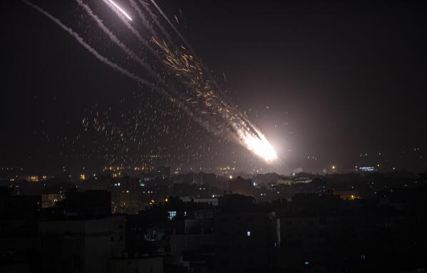 Rockets are launched from the Gaza Strip towards Israel, Monday, May. 10, 2021. Hamas militants fired dozens of rockets into Israel on Monday, including a barrage that set off air raid sirens as far away as Jerusalem, after hundreds of Palestinians were hurt in clashes with Israeli police at a flashpoint religious site in the contested holy city. (AP Photo/Khalil Hamra)