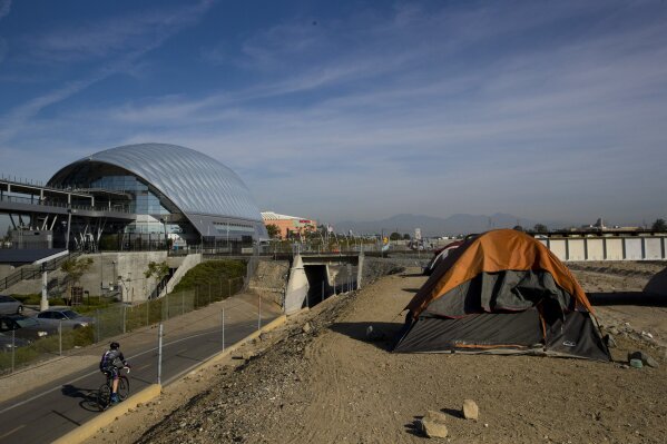 
              Homeless tents are pitched on the Santa Ana River trail near the Anaheim Regional Transportation Intermodal Center, a $185-million transportation center, Saturday, Dec. 2, 2017, in Anaheim, Calif. The number of homeless living in Orange County has climbed 8 percent over the last two years. In the United States, homelessness rose slightly in the last year to nearly 554,000, pushed up largely by increases on the West Coast, federal data shows. (AP Photo/Jae C. Hong)
            