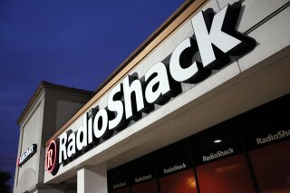 FILE - This Tuesday, Feb. 3, 2015 file photo shows a RadioShack store in Dallas.  RadioShack, the nearly century-old electronics retailer ubiquitous in malls for decades, has been pulled from brink of death — again. It’s the most prized name in the basket of retail brands that entrepreneur investors Alex Mehr and Tai Lopez have scooped up for a relative pittance since the coronavirus pandemic landed on U.S. shores.   (AP Photo/Tony Gutierrez, File)