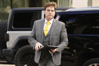 FILE - Dr. Craig Wright arrives at the Federal Courthouse, on Nov. 16, 2021, in Miami. Britain's high court ruled Thursday March 14, 2024 that an Australian computer scientist is not, as he claimed, the mysterious creator of the bitcoin cryptocurrency. Craig Wright has for eight years claimed that he was the man behind “Satoshi Nakamoto,” the pseudonym that masked the identity of the creator of bitcoin. (AP Photo/Marta Lavandier, File)