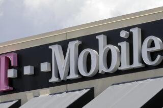 FILE - This photo taken Thursday, July 27, 2017, shows T Mobile sign at a store in Hialeah, Fla.  T- Mobile has agreed to pay $350 million, Friday, July 22, 2022,  to customers affected by a class action lawsuit filed after the company disclosed last August that personal data like social security numbers had been stolen in a cyberattack.(AP Photo/Alan Diaz, File)