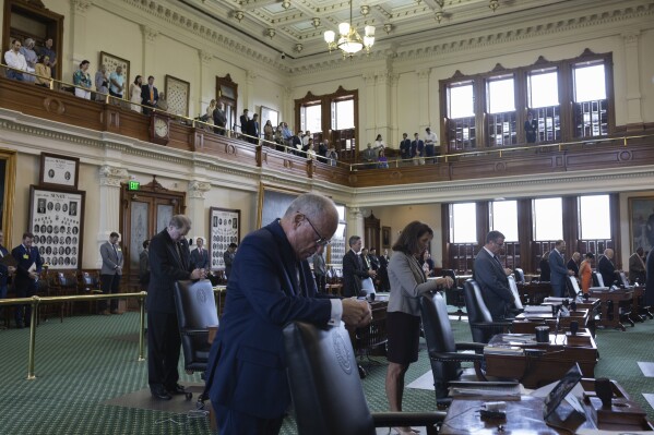 Texas State Senators bow their heads in prayer during the impeachment trial for suspended Attorney General Ken Paxton at the state capitol in Austin, Texas, Thursday, Sept. 14, 2023. (Eddie Gaspar/The Texas Tribune via AP, Pool)
