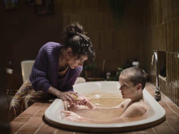 This image released by A24 shows Sally Hawkins, left, and Jonah Wren Phillips in a scene from "Bring Her Back." (Ingvar Kenne/A24 via AP)