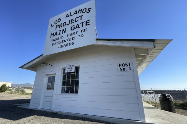 A sign marks a roadside rest stop that has been made to look like the historic security gate that all Manhattan Project workers passed through in Los Alamos, N.M., on June 26, 2023. The community is facing growing pains again, 80 years after the birth of the Manhattan Project, as it works to modernize the country's nuclear arsenal. (AP Photo/Susan Montoya Bryan)