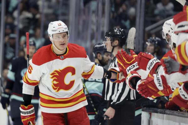 Calgary Flames defenseman Nikita Zadorov (16) is congratulated after scoring against the Seattle Kraken during the first period of an NHL hockey game, Friday, Jan. 27, 2023, in Seattle. (AP Photo/John Froschauer)