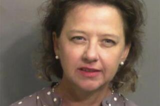 This jail booking photo provided by Glynn County Sheriff’s Office, shows Jackie Johnson, the former district attorney for Georgia’s Brunswick Judicial Circuit, after she turned herself in to the Glynn County jail in Brunswick, Ga, on Wednesday, Sept. 8, 2021.  A grand jury indicted Johnson on charges of violating her oath of office and obstructing police in her handling of the February 2020 killing of Ahmaud Arbery. The indictment accuses Johnson of using her position to try to shield Arbery’s killers from prosecution. She has denied any wrongdoing.  (Glynn County Sheriff’s Office via AP)