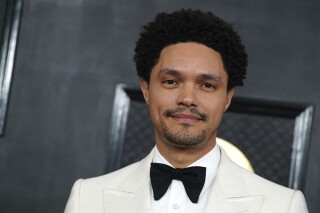 FILE - Host Trevor Noah arrives at the 65th annual Grammy Awards, Feb. 5, 2023, in Los Angeles. On Wednesday, Dec. 13, Noah announced that he will once again host the Grammy Awards in 2024. For those keeping count, the 66th Grammys marks his fourth consecutive year of hosting duties. (Photo by Jordan Strauss/Invision/AP, File)