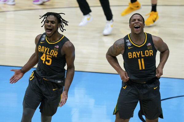 Baylor guard Davion Mitchell (45) and Baylor guard Mark Vital (11) celebrate at the end of the championship game against Gonzaga in the men's Final Four NCAA college basketball tournament, Monday, April 5, 2021, at Lucas Oil Stadium in Indianapolis. Baylor won 86-70. (AP Photo/Darron Cummings)