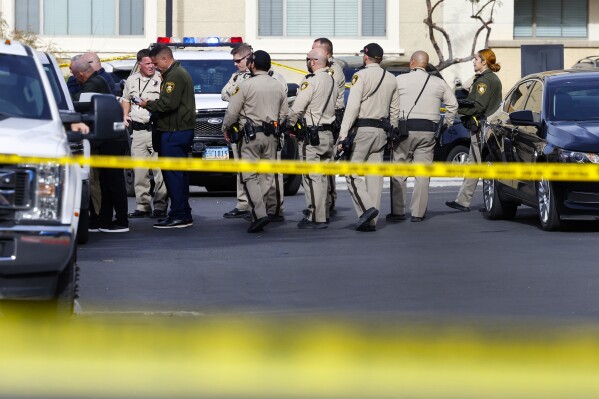 Las Vegas police investigate the scene of a shooting at a northwest valley apartment complex, Monday, Dec. 11, 2023 in Las Vegas. (Bizuayehu Tesfaye/Las Vegas Review-Journal via AP)