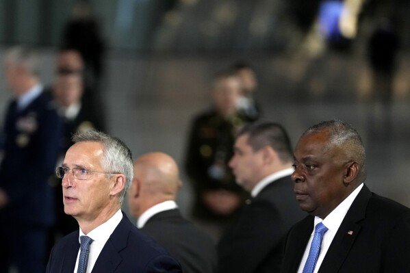 NATO Secretary General Jens Stoltenberg walks with United States Secretary of Defense Lloyd Austin prior to addressing a media conference on the sidelines of a meeting of NATO defense ministers at NATO headquarters in Brussels, Thursday, Oct. 12, 2023. (AP Photo/Virginia Mayo)