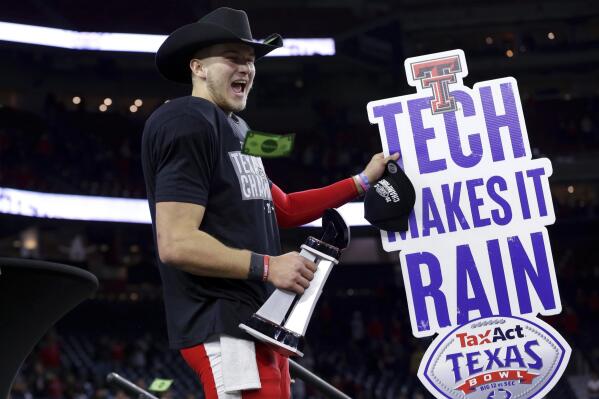 Texas Tech quarterback Tyler Shough waves a sign after the team's 42-25 win over Mississippi in the Texas Bowl NCAA college football game, early Thursday, Dec. 29, 2022, in Houston. (AP Photo/Michael Wyke)