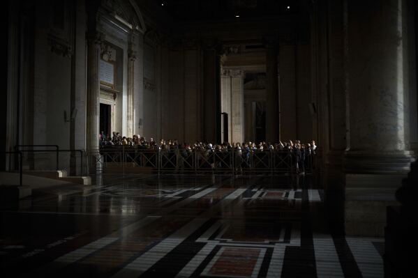 People line up as they enter St. Peter's Basilica to pay their respects to Pope Francis lying in state, at the Vatican, Thursday, April 24, 2025. (AP Photo/Emilio Morenatti)