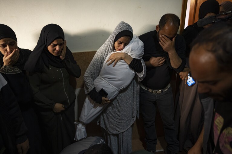 Members of the Abu Draz family mourn their relatives killed in the Israeli bombardment of the Gaza Strip, at their house in Rafah, southern Gaza, Thursday, April 4, 2024. (AP Photo/Fatima Shbair)