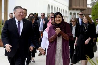 FILE - In this Feb. 20, 2020, file photo, U.S. Secretary of State Mike Pompeo, left, walks with Saudi ambassador to the United States Princess Reema Bint Bandar at Princess Reema's Palace in Riyadh. With Joe Biden re-emerging as the front-runner in the Democratic presidential race, Saudi Arabia's ambassador to the United States dismisses Biden's description of the kingdom as a "pariah." Ambassador Princess Reema bint Bandar Al Saud said in an interview with The Associated Press recent presidents have always carried on a good relationship between the two countries after taking office. (Andrew Caballero-Reynolds/Pool Photo via AP, File)