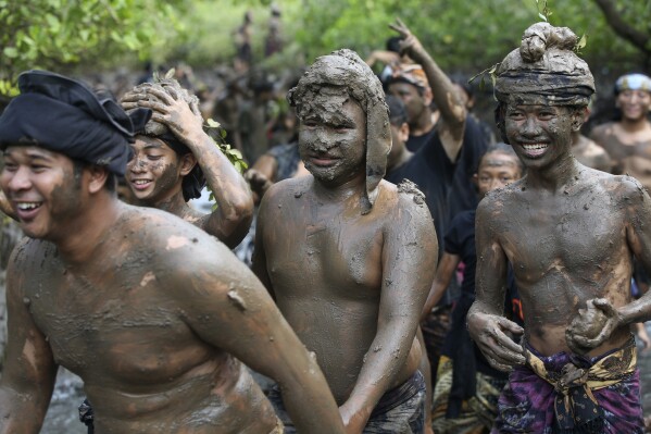 People of Kedonganan village participate in a mud bath purification ritual in a mangrove forest as part of Balinese Hindu New Year celebrations in Bali, Tuesday, March 12, 2024. (AP Photo/Firdia Lisnawati)