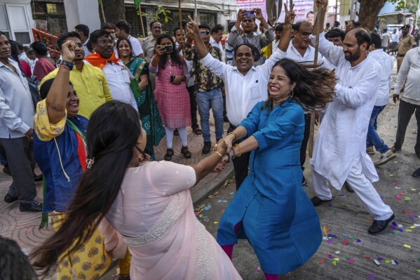 Supporters of Congress Party dance as they celebrate their party's lead during the counting of votes in India's national election in Mumbai, India, Tuesday, June 4, 2024. (AP Photo/Rafiq Maqbool)