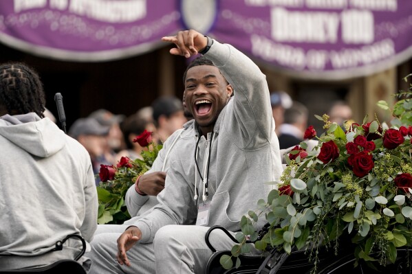 Alabama quarterback Jalen Milroe waves during a welcome event at Disneyland on Wednesday, Dec. 27, 2023, in Anaheim, Calif. Alabama is scheduled to play against Michigan on New Year's Day in the Rose Bowl, a semifinal in the College Football Playoff. (AP Photo/Ryan Sun)