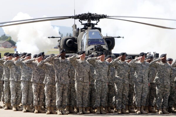FILE - In this Friday, May 13, 2011 file photo, Soldiers of 1AD attend a color casing ceremony of the First Armored Division at the US Army Airfield in Wiesbaden, Germany. The governors of the four German states that are home to critical U.S. military facilities are urging members of U.S. Congress to try and force President Donald Trump to back down from plans to withdrawal more than a quarter of American troops from the country. (AP Photo/Michael Probst, file)
