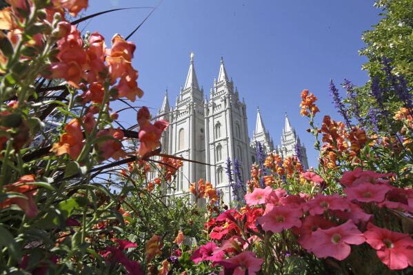 FILE - Flowers bloom in front of the Salt Lake Temple, at Temple Square, on Aug. 4, 2015, in Salt Lake City. The Church of Jesus Christ of Latter-day Saints on Tuesday, Nov. 15, 2022, came out in support of The Respect for Marriage Act under consideration in Congress after years of opposing recognition of same-sex marriage. (AP Photo/Rick Bowmer, File)