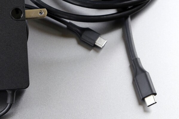 FILE - A USB-C cable is pictured in San Jose, Calif. Tuesday, March 10, 2015. Apple is ditching its in-house iPhone charging plug and falling in line with the rest of the tech industry by adopting USB-C, a more widely used connection standard. (AP Photo/Jeff Chiu, File)
