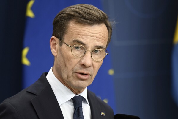 Swedish Prime Minister Ulf Kristersson makes a statement on the shooting of two Swedish soccer fans in Brussels on Monday, at Rosenbad, Stockholm, Tuesday, Oct. 17, 2023. Belgian police on Tuesday shot dead a suspected Tunisian extremist accused of killing two Swedish soccer fans in a brazen shooting on a Brussels street before disappearing into the night. (Fredrik Sandberg/TT News Agency via AP)