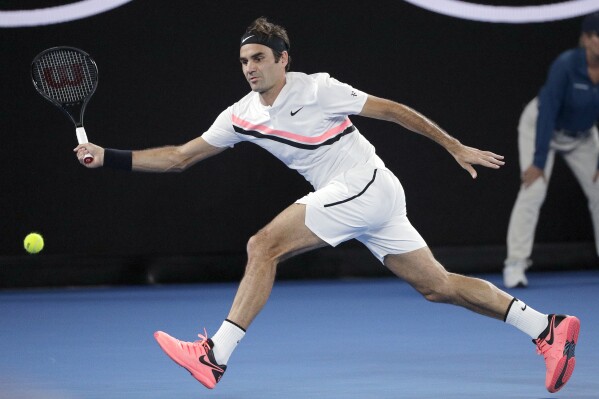 FILE - Switzerland's Roger Federer hits a forehand to Croatia's Marin Cilic during the men's singles final at the Australian Open tennis championships in Melbourne, Australia, on Jan. 28, 2018. An online auction that starts Wednesday Sept. 20, 2023 is offering a Federer outfit from his winning run at the 2018 Australian Open. That was his 20th and final Grand Slam title. (AP Photo/Dita Alangkara, File)