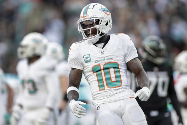 Miami Dolphins wide receiver Tyreek Hill (10) reacts during the first quarter of an NFL football game against the New York Jets, Friday, Nov. 24, 2023, in East Rutherford, N.J. (AP Photo/Adam Hunger)
